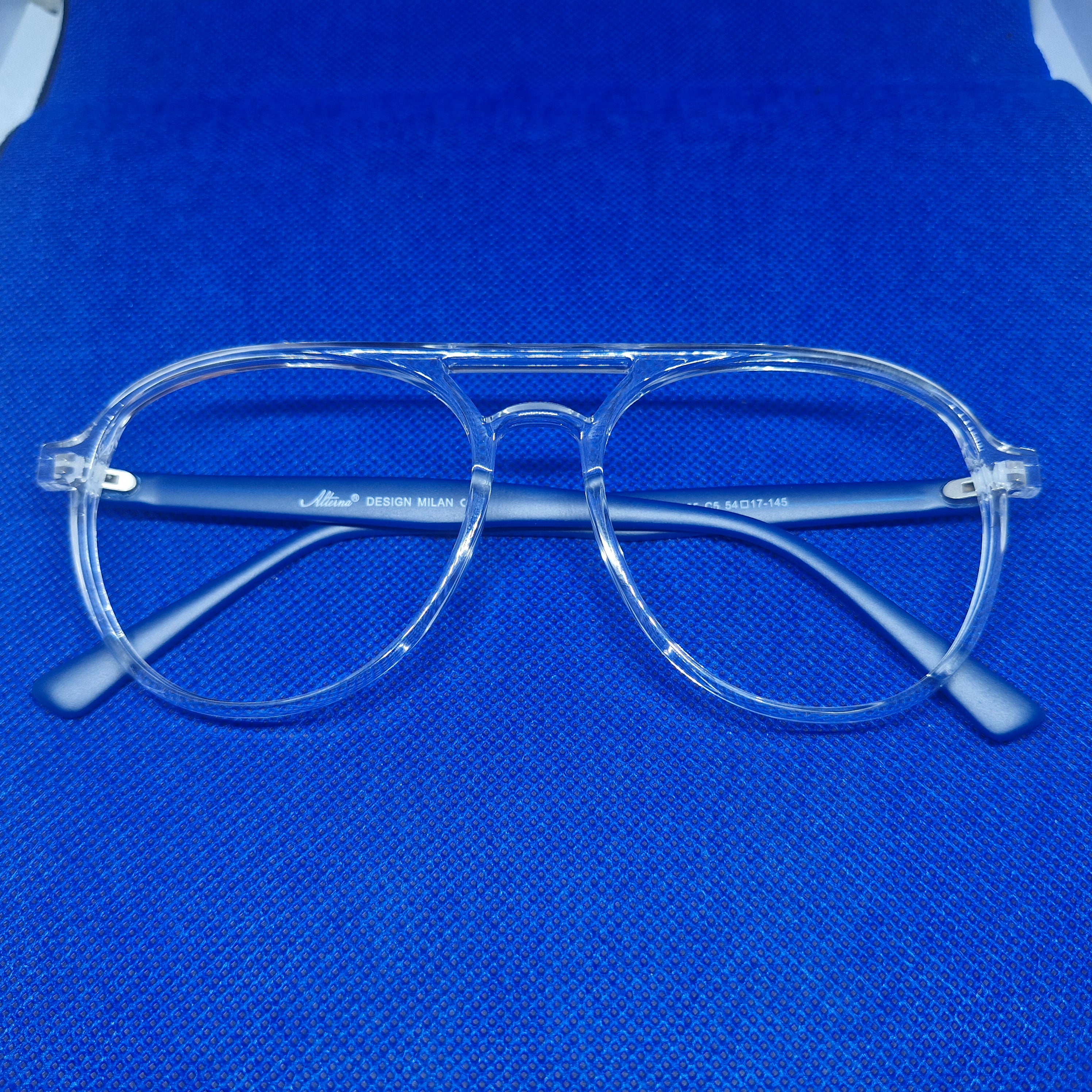 Armazón de ACETATO marca ALTERNA (transparente y varillas azules) + Cristales Ópticos CR39 con capa AR, protección 100% UV.